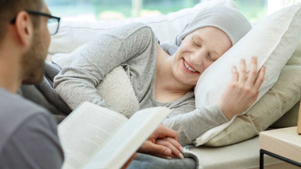 Reading book to cancer survivor Siena Hospice
